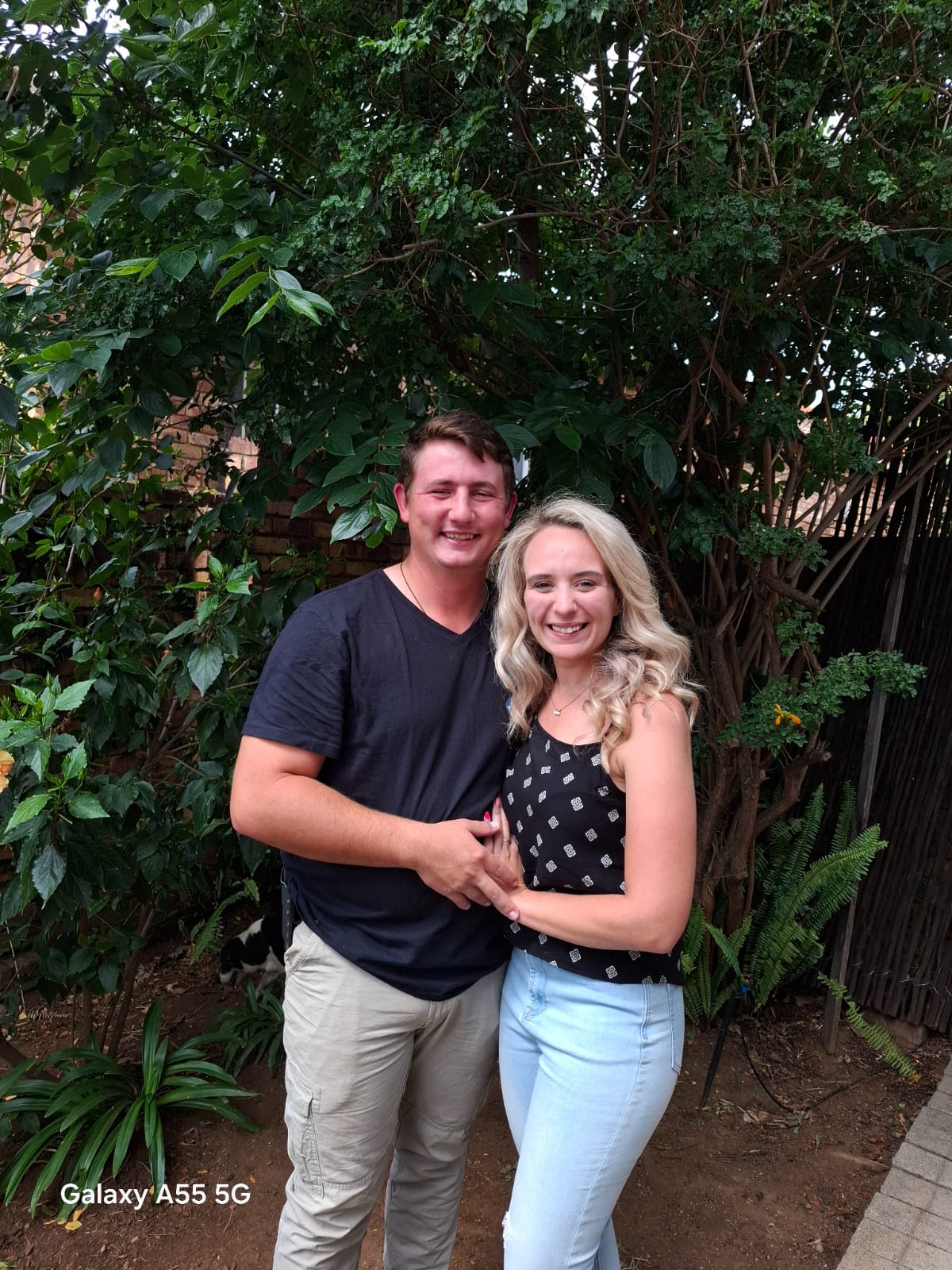 Michelle and Gerhardt smiling in a garden
